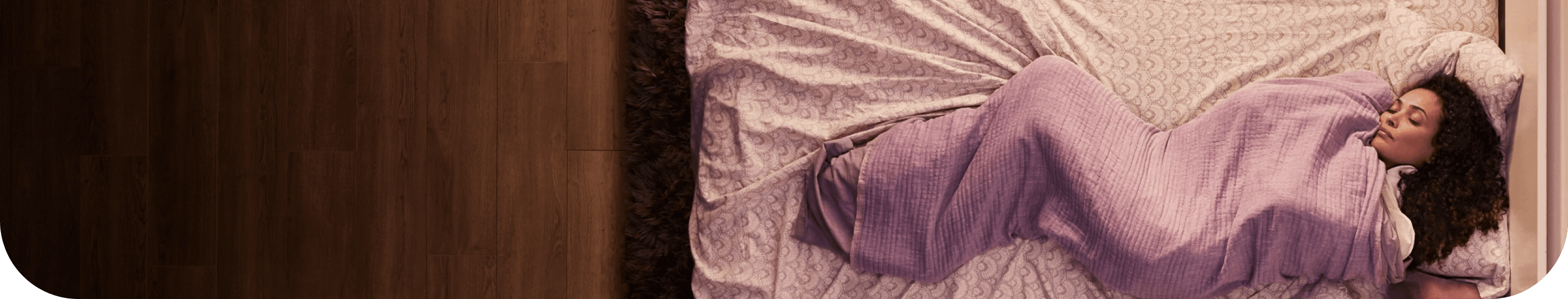 A woman asleep in her bed